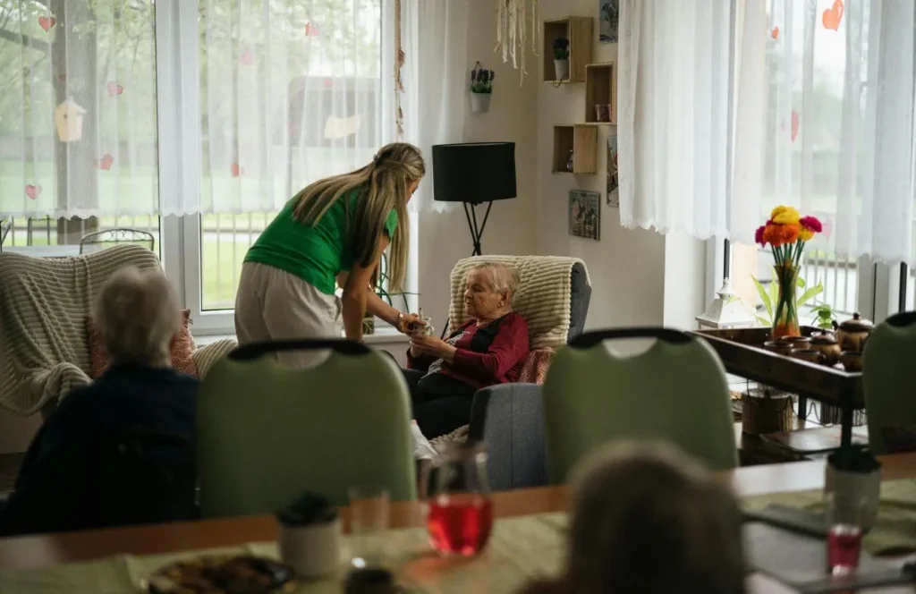 Home carer helping elderly resident with cleaning and household tasks in Mosman