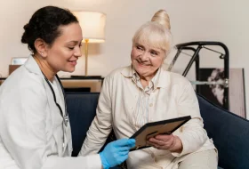 Compassionate caregiver providing home care services to elderly patient in Sydney